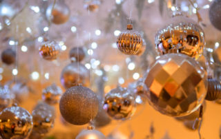 Close up of a variety of hanging silver baubles including matte, shiny and glittery.