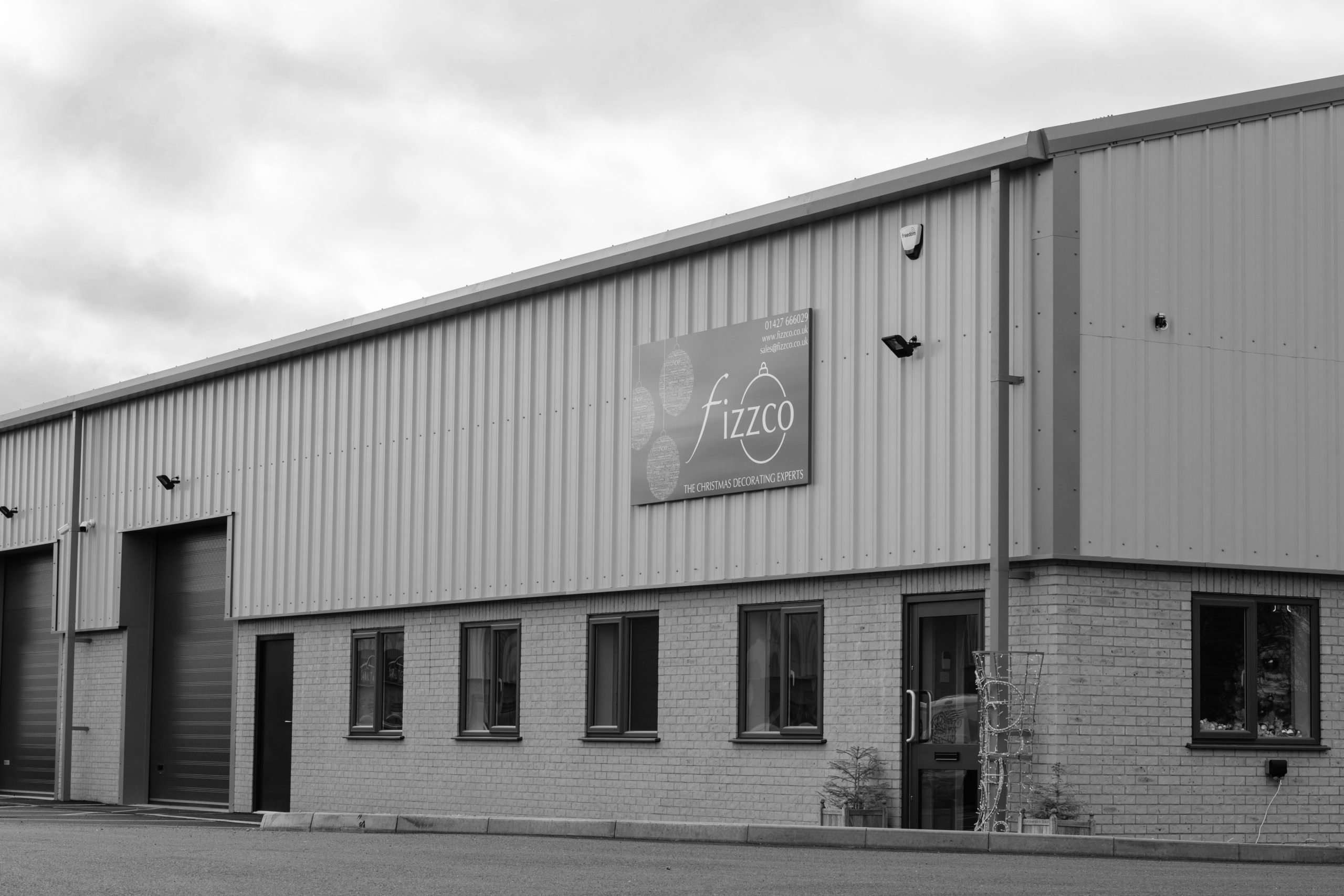 A black and white image of the oustide of Fizzco's office building.