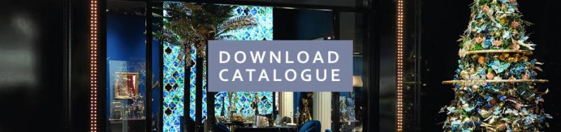 Website banner featuring a Christmas tree decorated with blue and gold baubles and flora, and the words download catalogue in the centre of the banner.