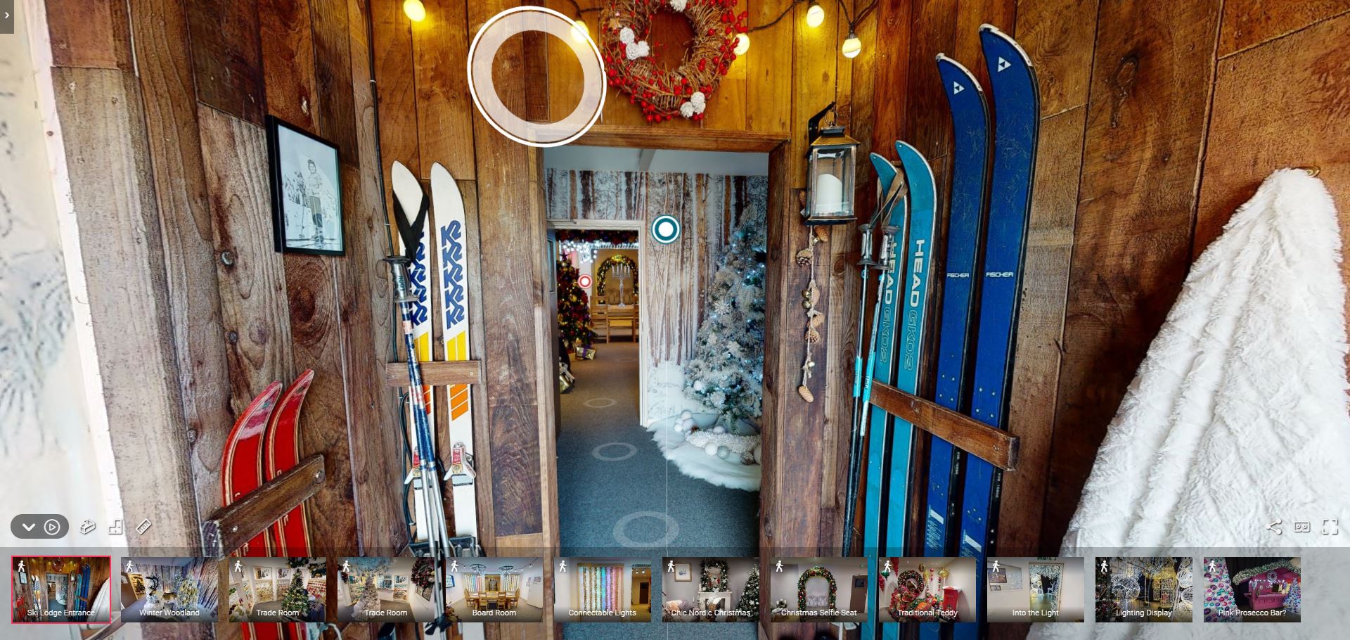 A still image from Fizzco's online Christmas showroom tour, showing the entrance of the showroom with skis attached to the wooden wall.