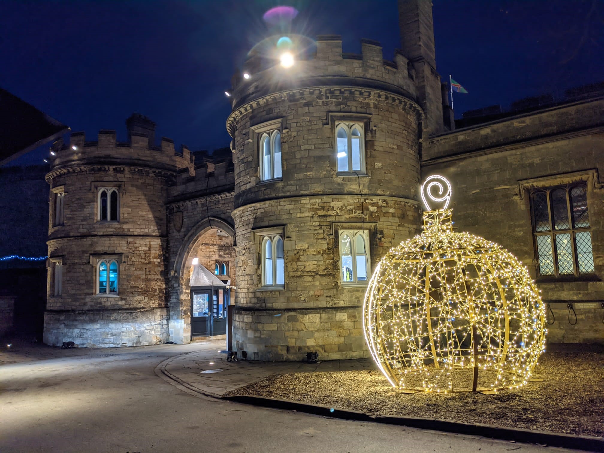 Gold light up bauble motif displayed outside the entrance to Lincoln Castle.