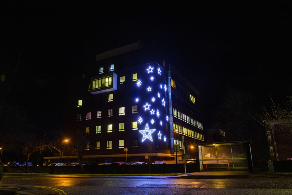 Light-up blue star motifs displayed on the outside building of County Hospital designed by Fizzco Projects.