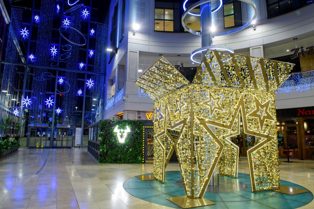 Large Light up gold Star present box motif with the top open, placed in the centre of The Light Shopping Centre.