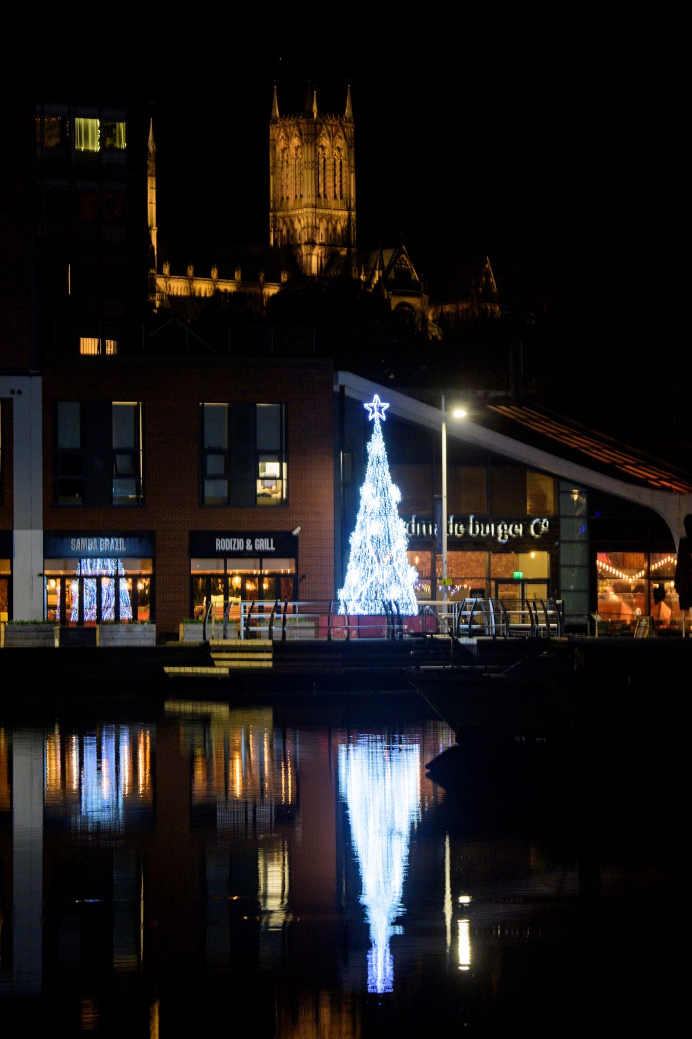 Bright white light up cone Christmas Tree displayed in the Brayford in Lincoln.