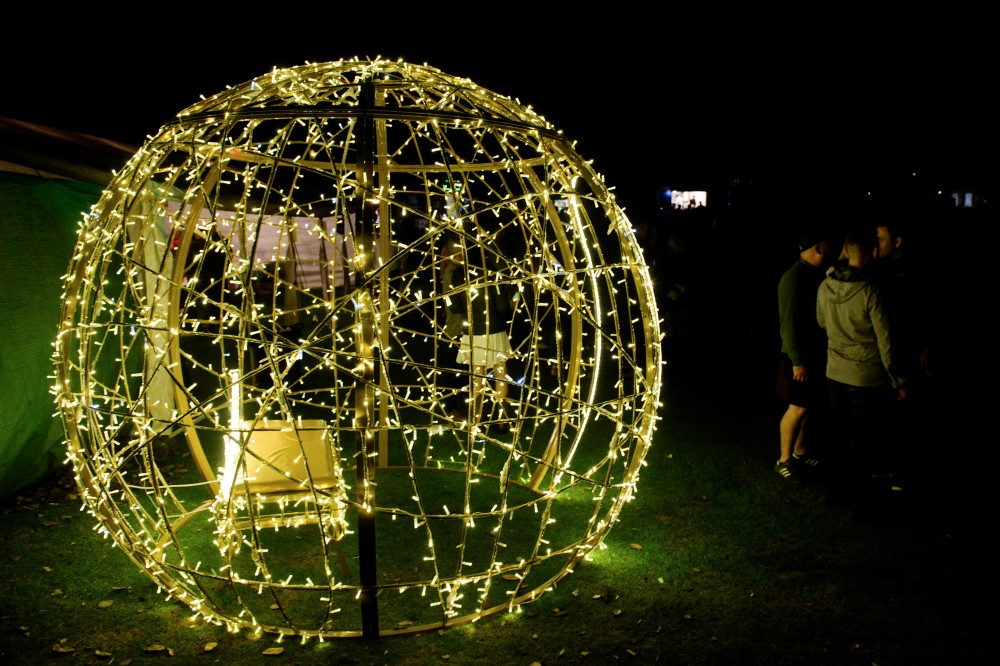Light-up gold bauble motif displayed outdoors as a selfie point for visitors.
