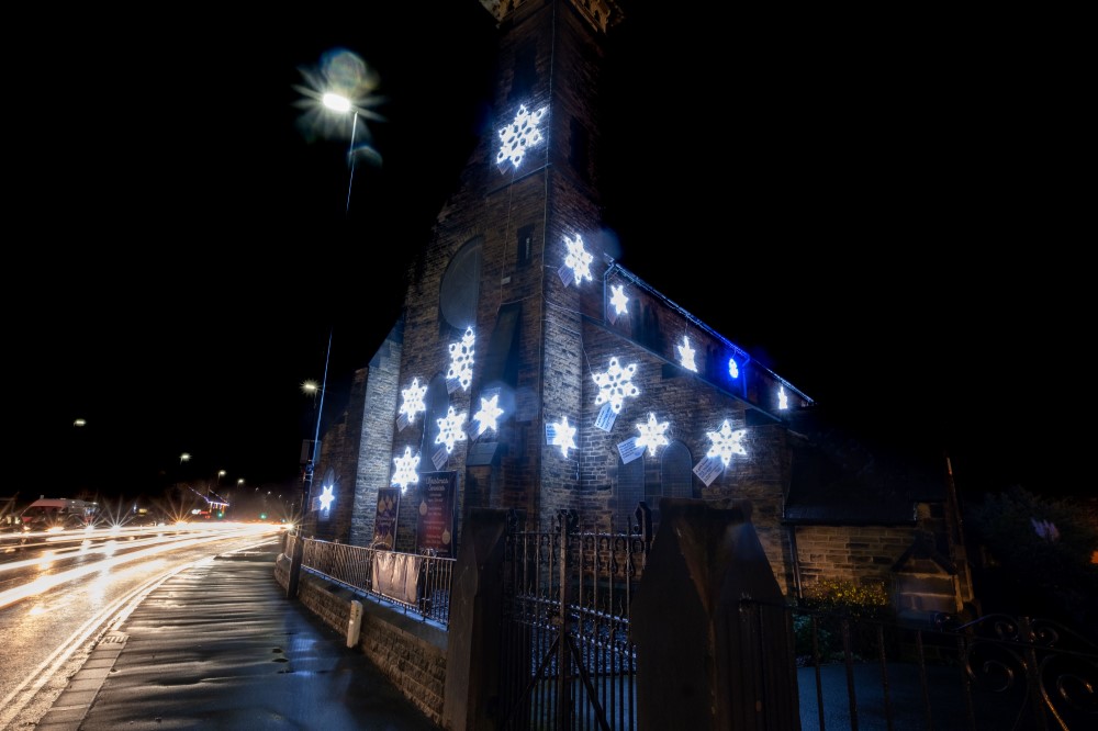 Bright White Snowflake Motifs by Fizzco Projects displayed outside on St John's Church.
