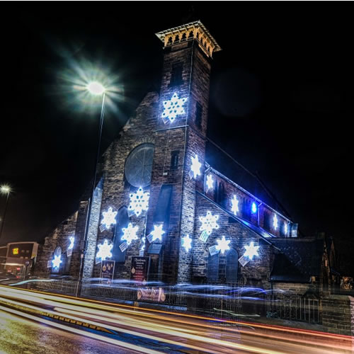 Bright White Snowflake Motifs by Fizzco Projects displayed outside on St John's Church.