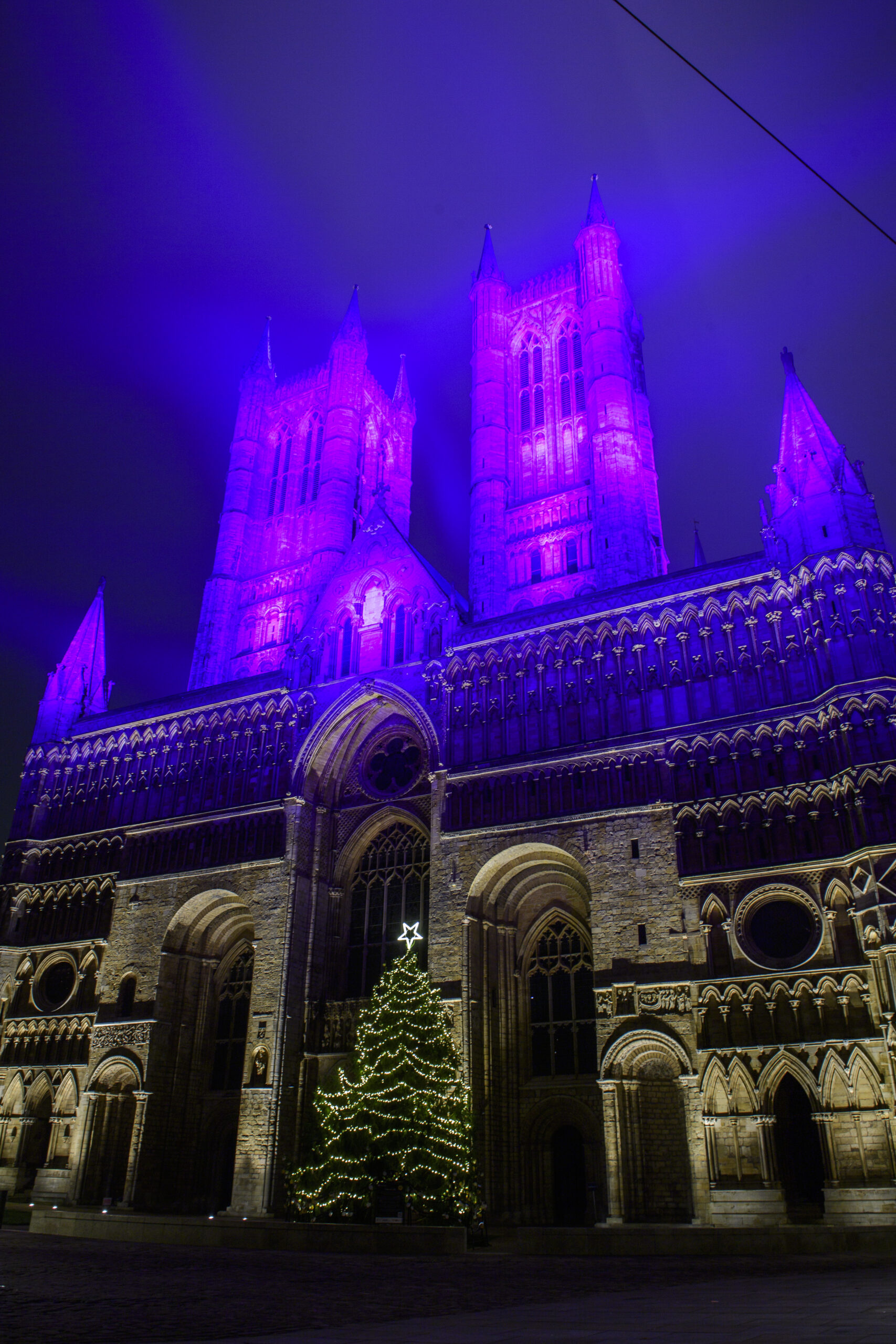 Christmas Tree decorated with Warm White Lights displayed outside Lincoln Cathedral for the Christmas season.