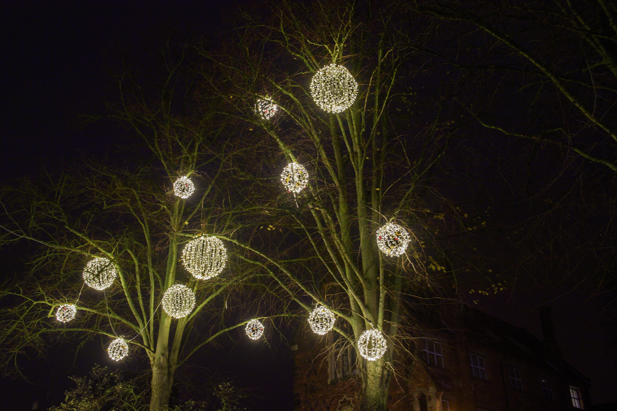 Light-up 3D bauble motifs by Fizzco Projects displayed on trees in Lincoln City Centre for the Christmas period.