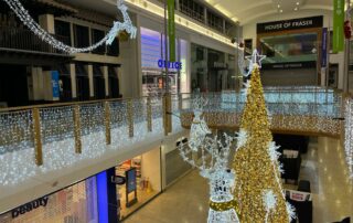 An installation at Chantry Place Shopping Centre featuring a luxurious gold and white Christmas display designed by Fizzco Projects.