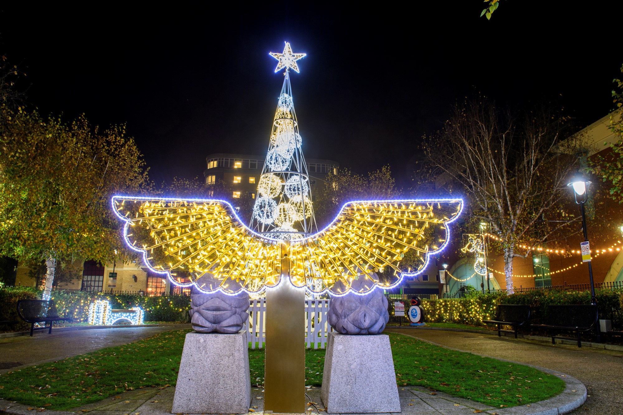 2D angel wings selfie pod. Perfect photo opportunity. Featuring warm white and white commercial outdoor lighting. 